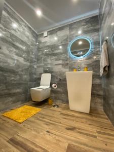 a bathroom with a toilet and a sink at DV13 Luxury Suite Sofia Center in Sofia