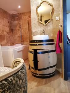 a bathroom with a large barrel sink and a tub at Romantisme et glamour avec spa, piscine et jardin in Dijon