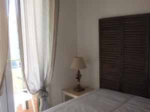 a bedroom with a bed and a dresser and a window at hippocampe f2 in Fréjus