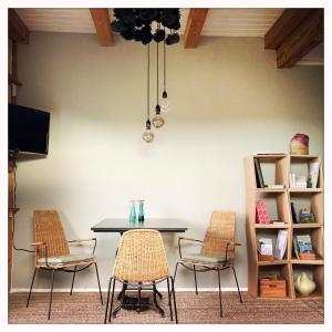 a table and chairs with a table and shelves at Oberstaufenblick.Allgäu in Stiefenhofen