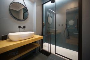 a bathroom with a sink and a shower at Domus Aurea Luxury Apartment Cefalù in Cefalù