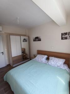 a bedroom with a large bed and a mirror at Paparoúna 5 min from beach in Nikiti