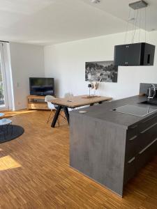 a living room with a kitchen and a table at MONzeit in Monschau +37 photos