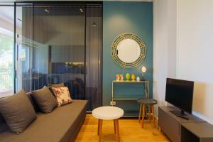 a living room with a couch and a mirror at Domus Aurea Luxury Apartment Cefalù in Cefalù