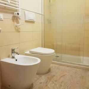 a bathroom with a sink and a toilet and a shower at B&B da Natallia in Ronco allʼAdige +13 photos