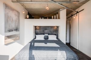 a bedroom with a large bed in a room at Le Garage in Theux