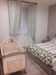 a bedroom with a bed and a baby crib at Casa Calù in Genoa