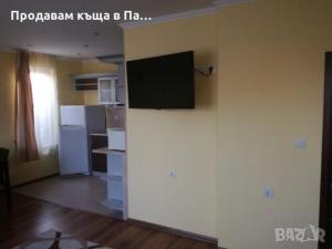 a living room with a television on a wall at Guest Room Descreet in Pavel Banya