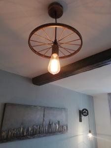 a ceiling fan and lights in a room at Schlafladen in Melsungen +5 photos
