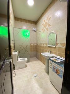 a bathroom with a toilet and a sink at أركانا للشقق المخدومة in Tabuk +50 photos