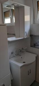 a white bathroom with a sink and a mirror at SAN MARKO 2 in Lovran +28 photos