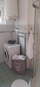 a small kitchen with a washing machine and a washer at SAN MARKO 2 in Lovran
