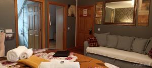 a room with a couch and a table with a laptop on it at Outlander Boutique B&B ONLY ADULT Suite in Cruden Bay +36 photos