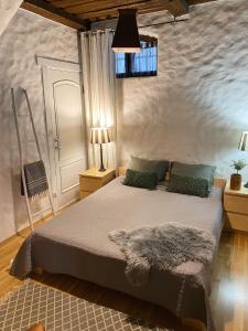 a bedroom with a large bed with a furry blanket at Kolme Venna Villa in Pärnu