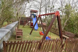 a playground with two swings and a slide at Fener Motel in Şile