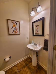 a bathroom with a sink and a toilet at Cozy House near Ole Miss & M-Trade! in Oxford