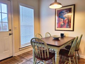 a dining room with a wooden table and chairs at Cozy House near Ole Miss & M-Trade! in Oxford