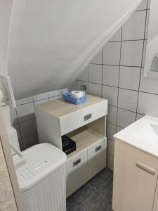 a bathroom with a white cabinet and a sink at Kiberosa in Isola delle Femmine