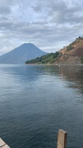 a large body of water with a mountain in the background at Cabañas de Tzununa in Tzununá