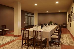 a long dining room with a long table and chairs at Hotel Quinta Do Furao in Santana