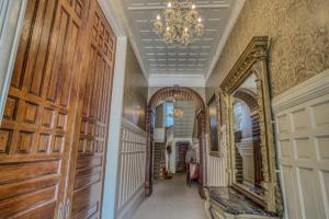 a hallway with a mirror and a chandelier at Mount Vernon Apartment Rear in Baltimore