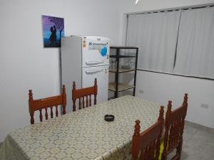 a kitchen with a refrigerator and a table and chairs at Norte Alojamiento in Belén