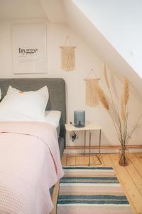 a bedroom with a bed and a rug at HYGG INN Ferienhaus in Heiligendamm