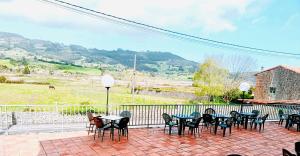 a group of tables and chairs on a patio at Hotel Alameda in Villaviciosa
