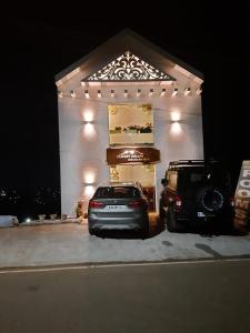 a car parked in front of a garage at night at Sunset Valley Holiday Inn in Ooty