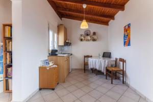 a kitchen with a table and a dining room at Ioannis Appartment in Heraklio Town
