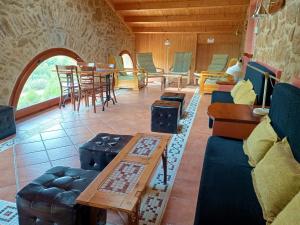 a living room with couches and a table and chairs at Masia Rovira in Pinell de Solsones