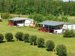 an aerial view of a house with bushes in a field at Domki u Dobrusi in Mikołajki