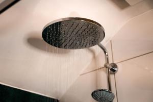 a shower head with water pouring out of it at B&B Achterom in Thorn