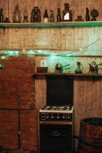 a kitchen with a stove and shelves with lights at Sunny Nights Homestead Historic House in Gataučiai