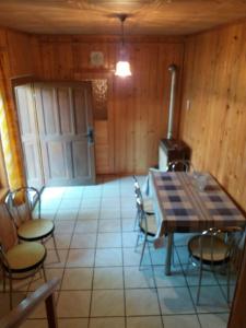 a room with a table and chairs and a stove at Guest House - Wai derhim in Sibiu