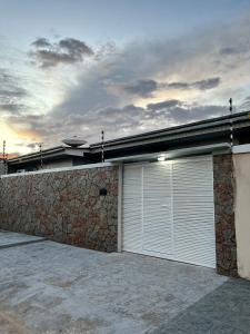 ボア・ヴィスタにあるApartamento em Boa Vistaの二つのガレージドアと石壁の家