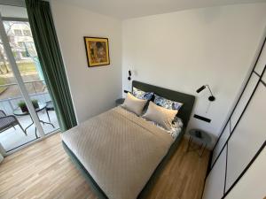 Кровать или кровати в номере Alėjos Apartmentai Comfort