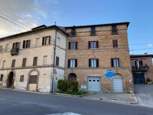 um velho edifício de tijolos ao lado de uma rua em L'angolo di Costalpino em Siena