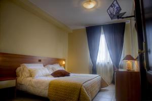Postel nebo postele na pokoji v ubytování Hotel Tuscania Panoramico