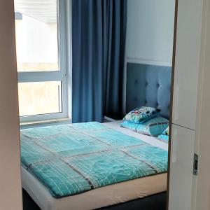 a bedroom with a bed and a window at Apartament Bel Mare in Międzyzdroje