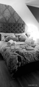 a black and white photo of a bed with cats laying on it at Outlander Boutique B&B King in Cruden Bay