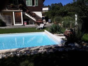 a swimming pool in the yard of a house at Chalet Norev in Saint-Martin-du-Mont