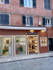 a store on a street next to a building at Piccolo Centrale in Corfu Town