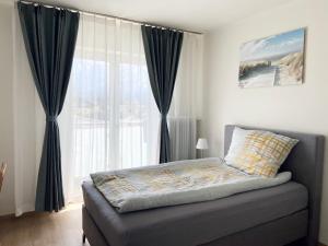 a bedroom with a bed and a large window at Wohnen mit Bergausblick in Wals