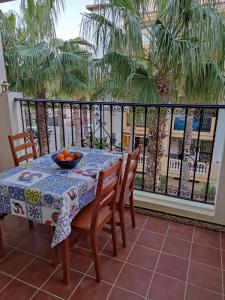 a table with a bowl of fruit on a balcony at Aldea del Mar in Torrevieja