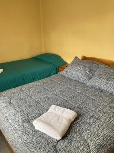 two beds sitting next to each other in a room at Hostal Balmaceda in Punta Arenas
