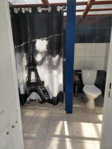 a bathroom with a shower curtain with the eiffel tower at Domki u Dobrusi in Mikołajki +49 photos