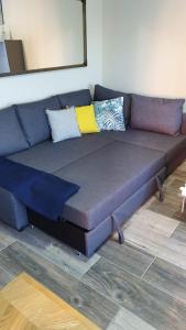 a blue couch with pillows on it in a room at Apartamento Marina el Puerto in El Puerto de Santa María
