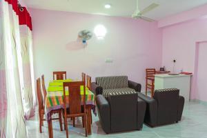 a dining room with a table and chairs and a fan at Lakeside Villa in Anuradhapura