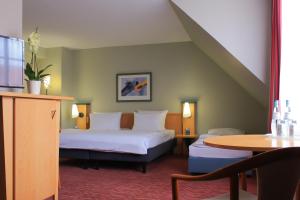 Ένα ή περισσότερα κρεβάτια σε δωμάτιο στο HKK Hotel Wernigerode